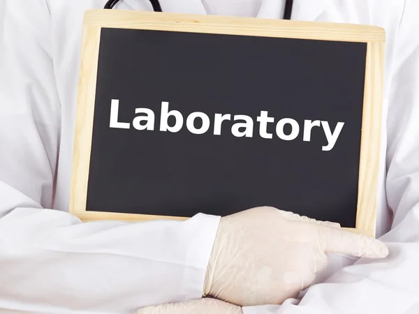 Doctor shows information on blackboard: laboratory — Stock Photo, Image