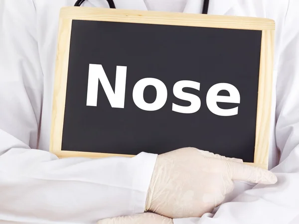 Doctor shows information on blackboard: nose — Stock Photo, Image