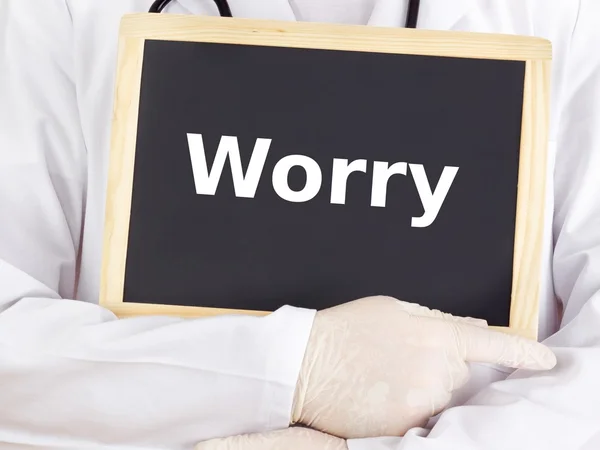 Doctor shows information on blackboard: worry — Stock Photo, Image