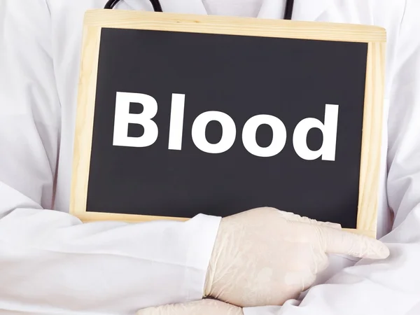 Doctor shows information on blackboard: blood Stock Photo