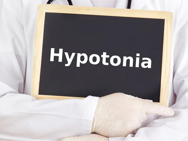 Doctor shows information on blackboard: hypotonia — Stock Photo, Image