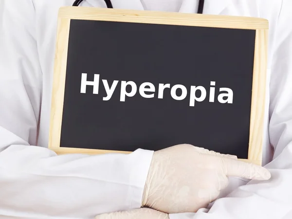 Doctor shows information on blackboard: hyperopia — Stock Photo, Image