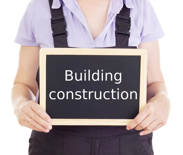 Craftsperson with blackboard: building construction — Stock Photo, Image