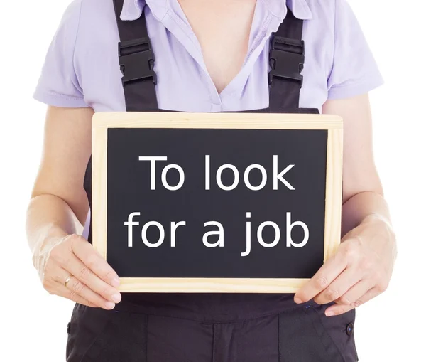 Craftsperson with blackboard: to look for a job — Stock Photo, Image