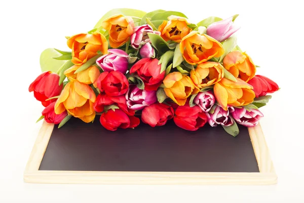 Bunch of tulips with blackboard — Stock Photo, Image