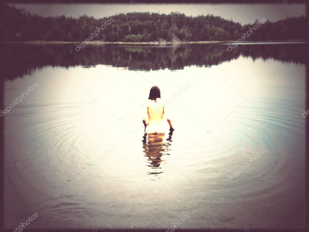 Vintage style image of nude woman in dark lake