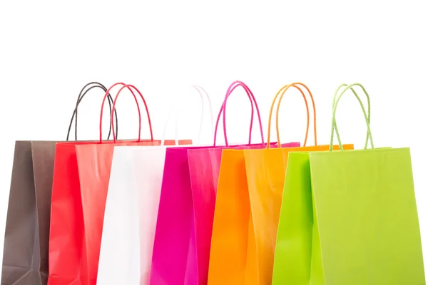 Seis sacos de compras coloridos em fundo branco — Fotografia de Stock