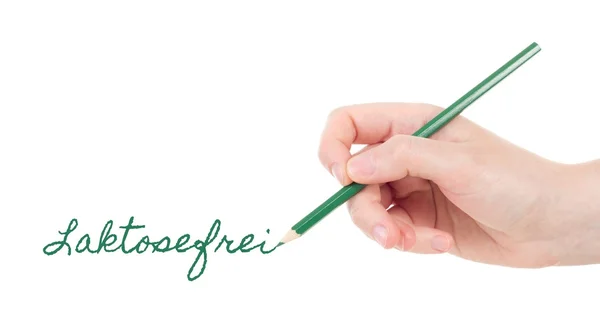Mão branca com lápis verde escrita laktosefrei — Fotografia de Stock