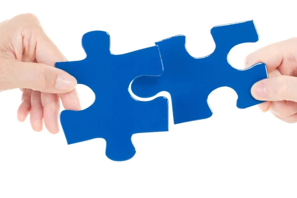 Putting the next pieces together for solving the jigsaw — Stock Photo, Image