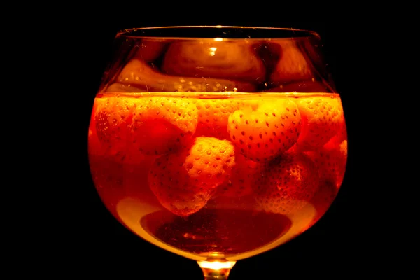 Lighted glass filled with strawberry punch — Stock Photo, Image