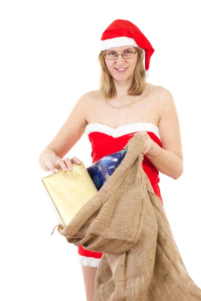 Happy Mrs. Claus taking gifts out of her jute bag — Stock Photo, Image
