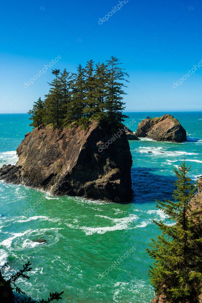 Island rock with pine trees on top near Secret Beach