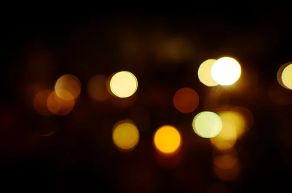 Foto de luzes bokeh no fundo preto — Fotografia de Stock