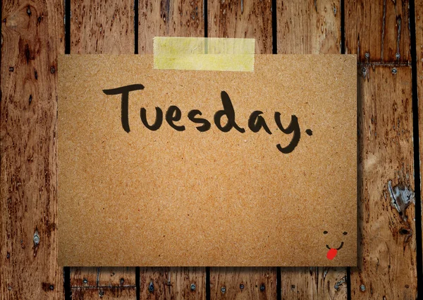 Tuesday on note paper with wooden background — Stock Photo, Image
