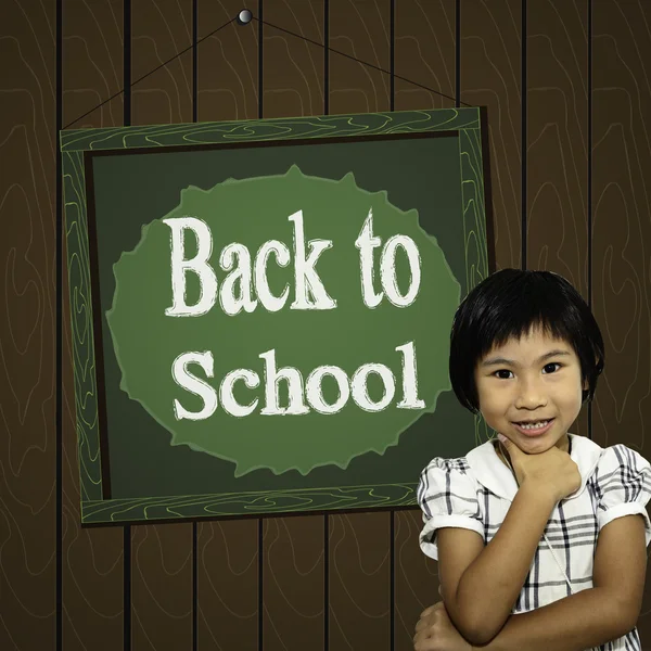 Happy Asian girl standing in front of Back to school green board — Stock Photo, Image