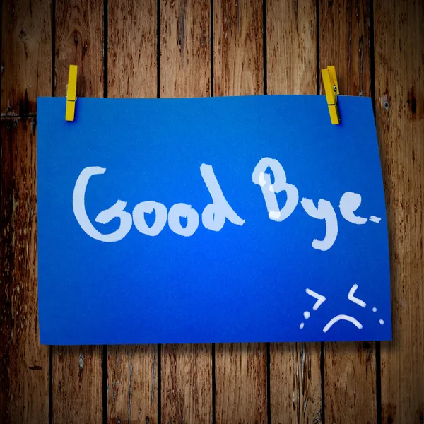 Good bye note paper and clothes peg on a wooden background with — Stock Photo, Image