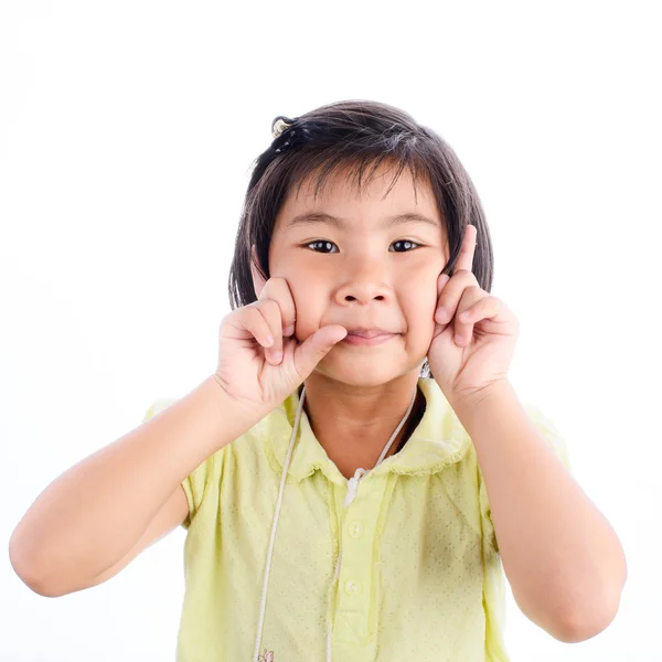 Linda niña en amarillo haciendo cara divertida — Foto de Stock