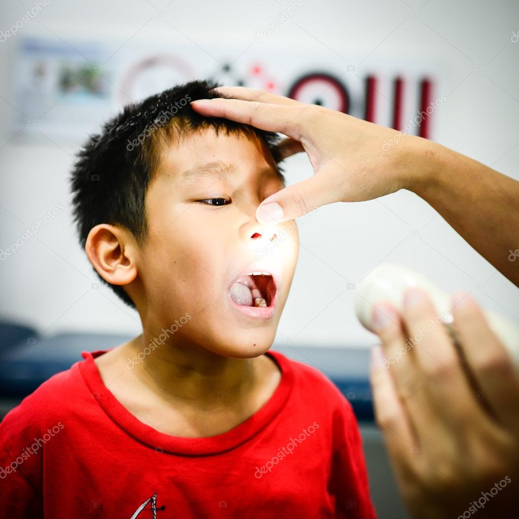 Boy showing his throat to doctor