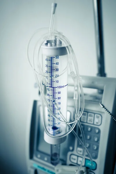 Partial view of a transparent drip bag and tubing against a whit — Stock Photo, Image