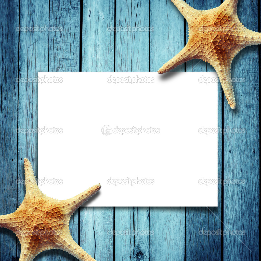 Star fish and card on a wooden boards