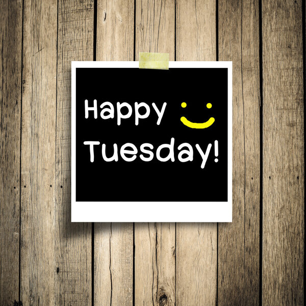 Happy Tuesday on grunge wooden background with copy space