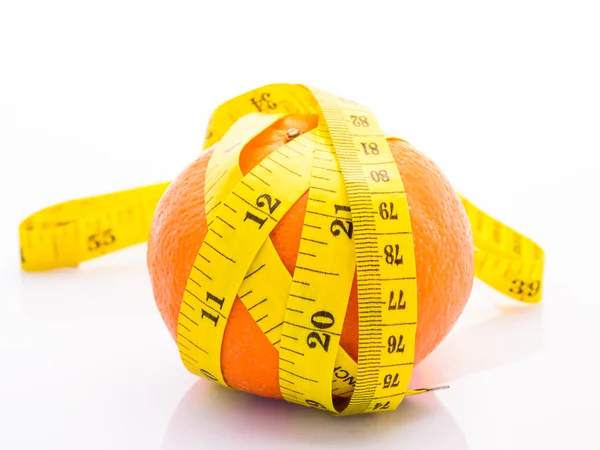 Orange with yellow measuring tape wrapped around it. On a white — Stock Photo, Image