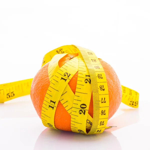 Orange with yellow measuring tape wrapped around it. On a white — Stock Photo, Image