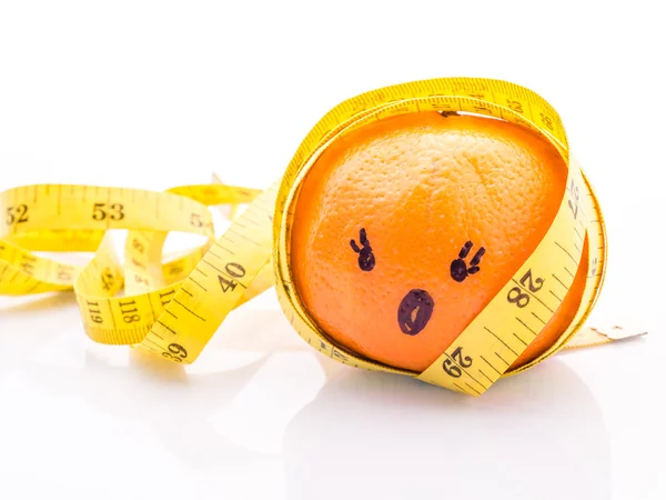 Funny face Orange with yellow measuring tape wrapped around it. Stock Picture