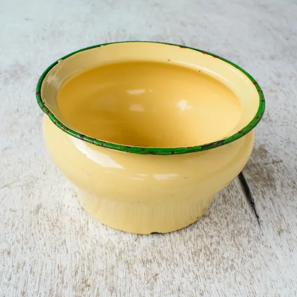 Yellow jug on white wood background — Stock Photo, Image