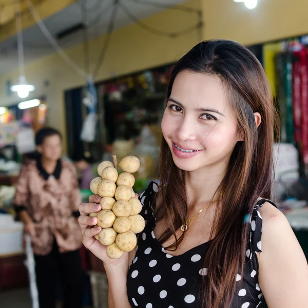 Aziatische vrouw met wollongong vruchten op de markt — Stockfoto