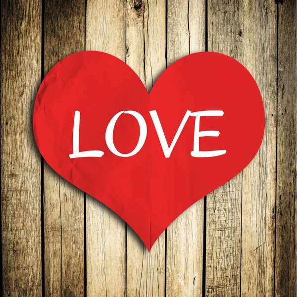 Na starej drewnianej ścianie symbol miłości — Zdjęcie stockowe