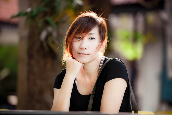 Beautiful Asian woman thinking in the park — Stock Photo, Image