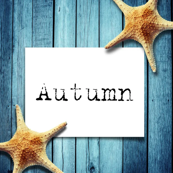 Note paper and autumn message,Star fish on wooden boards — Stock Photo, Image