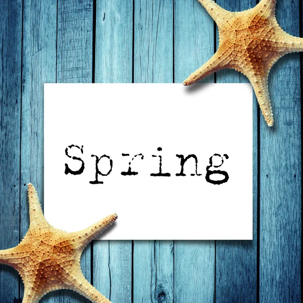 Note paper and spring message,Star fish on wooden boards — Stock Photo, Image