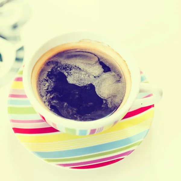 A cup of coffee on white table with retro filter effect — Stock Photo, Image