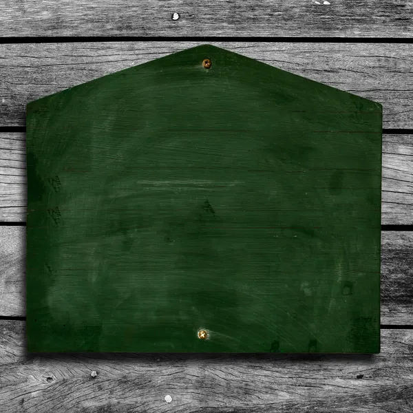 Green chalkboard on wooden background with clipping path