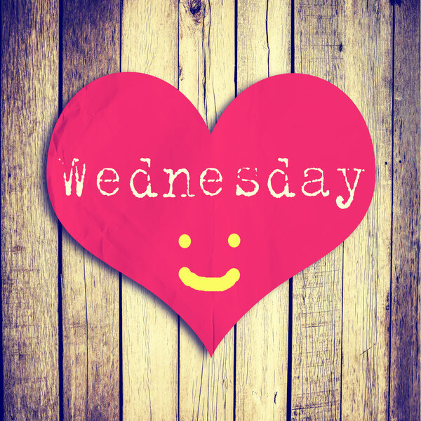 Love Wednesday on red heart shape with wooden wall