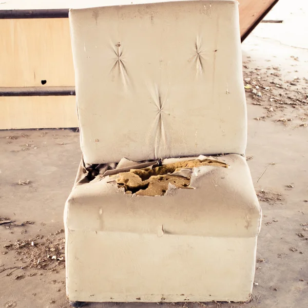 Old torn and dirty sofa in old house.