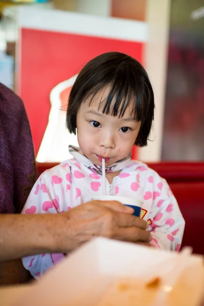 Portrait of happy little girl drinking water. — Stock Photo, Image