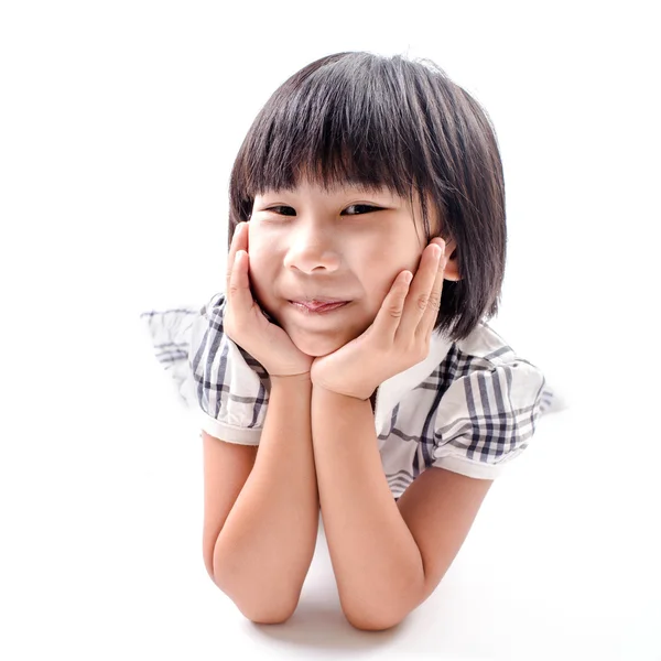 Pretty the little girl lies on the white. It is isolated on a wh — Stock Photo, Image