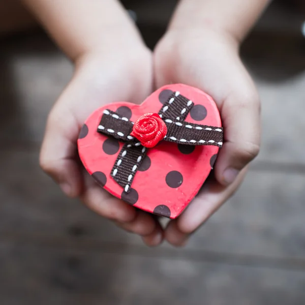 Red heart box in child's hands — Stock Photo, Image