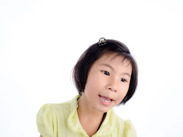 Cute little girl in yellow making funny face — Stock Photo, Image