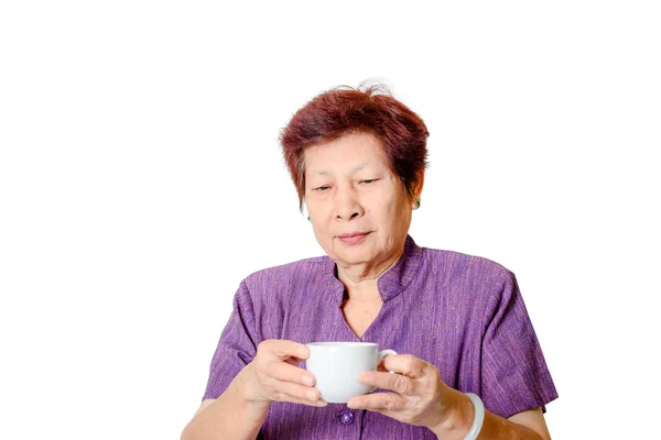 Old woman with a cup of coffee or tea — Stock Photo, Image