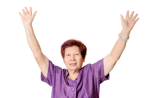 Portrait of a cheerful senior woman gesturing victory over a whi — Stock Photo, Image