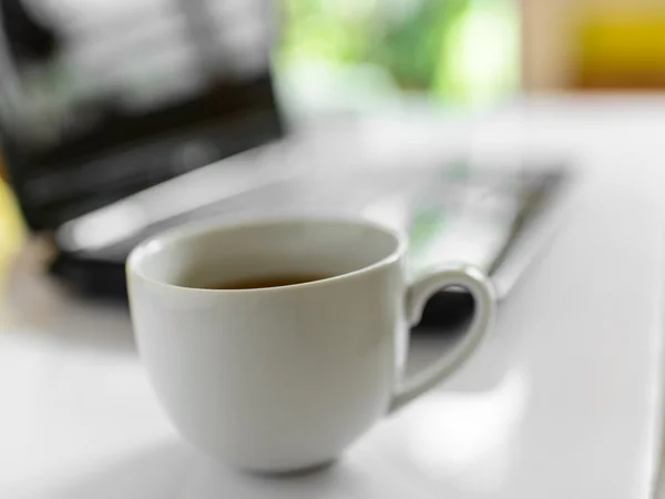 Xícara de café e laptop para negócios, foco seletivo no café . — Fotografia de Stock