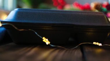 Yemek dağıtım konteynırlarının Noel dekoru. Eller alınıyor ve masaya konuyor. Yılbaşı arifesi terfisi. Hazır sıcak sipariş, tek kullanımlık plastik kutu. Bayramlarda yemek şirketinde çalışıyorum.. 