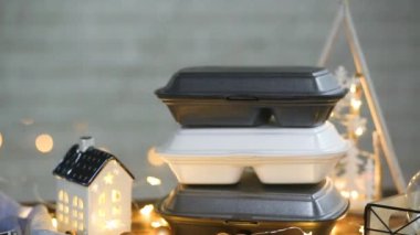 Elle alınır ve tek kullanımlık plastik kutudan sipariş verilir. Yemek dağıtım konteynırlarının Noel dekoru. Yılbaşı gecesi promosyonu. Bayramlarda yemek servisi. Peri ışıkları, ev