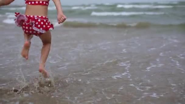 Little Girl Red Swimsuit Playing Beach Sea Wave Jumping Running — Video Stock