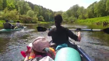 Family kayak trip. Mom and daughter rowing a boat on the river, a water hike, a summer adventure. Eco-friendly and extreme tourism, active and healthy lifestyle. Timelapse, accelerated video