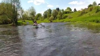 Family kayak trip. An elderly married couple with a grandson rowing a boat on the river, a water hike, a summer adventure. Age-related sports, mental youth and health, tourism, active old age